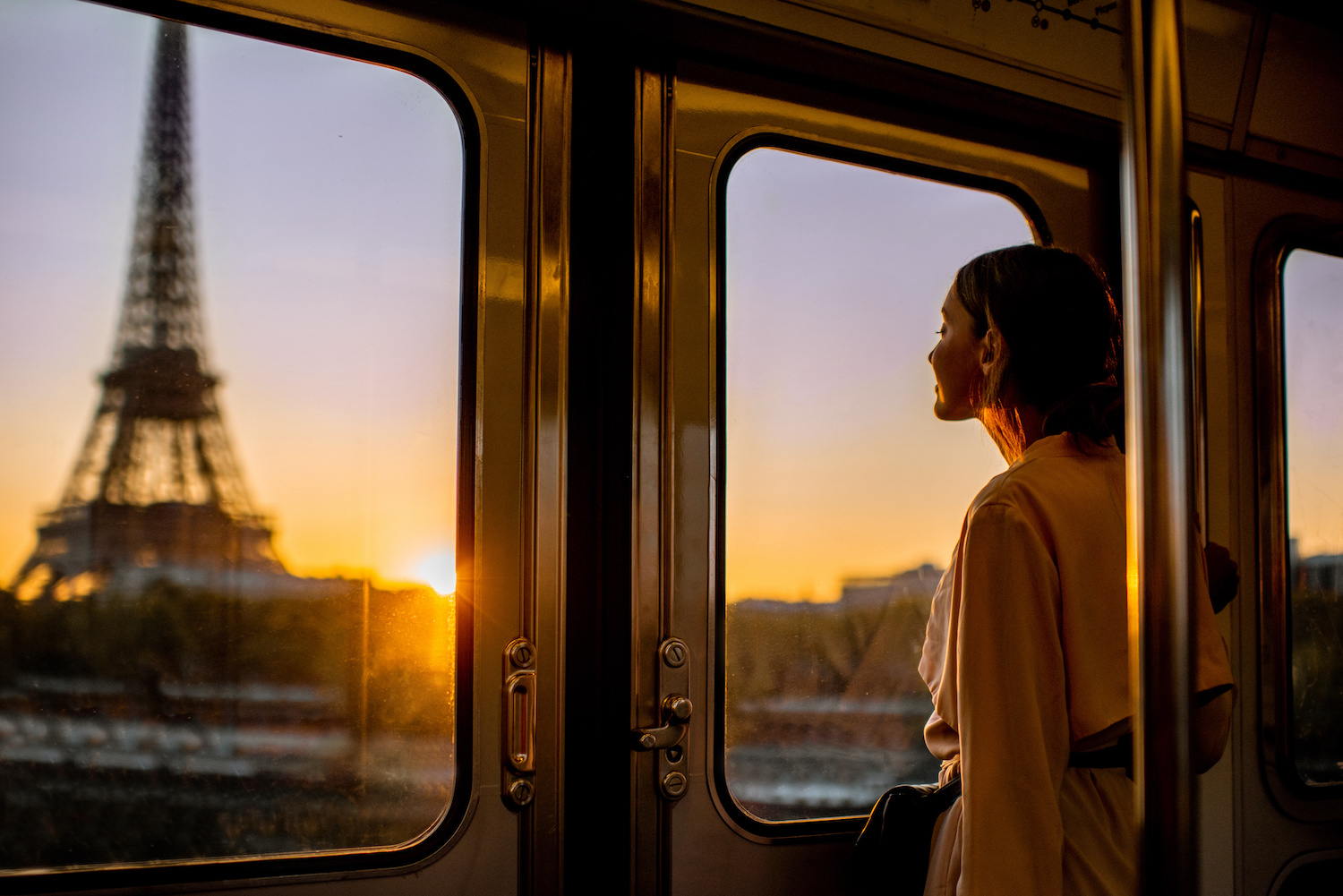 Woman watching the Eiffel tower from the subway - Paris France hotel des marronniers access