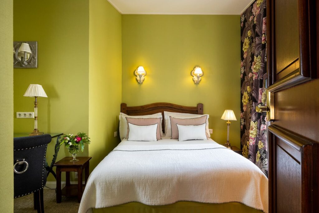 hotel in Paris - room with matrimonial bed, white, green fabric, flower curtains and door open - double room boutique hotel