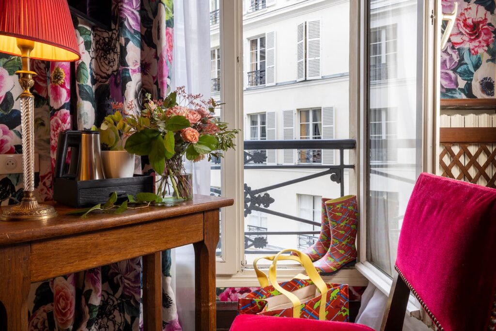 window open over Parisian building, desk, courtesy tray and chair - double room boutique hotel