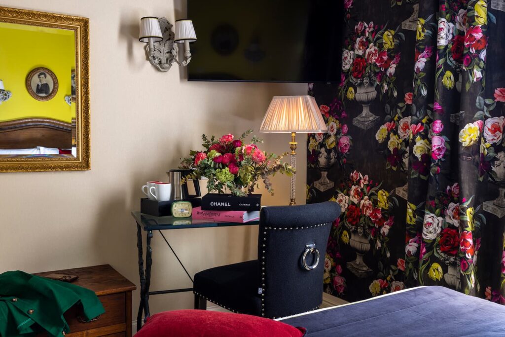hotel in Paris - desk, flowers, books, flower fabrics and mirror - romantic room Paris