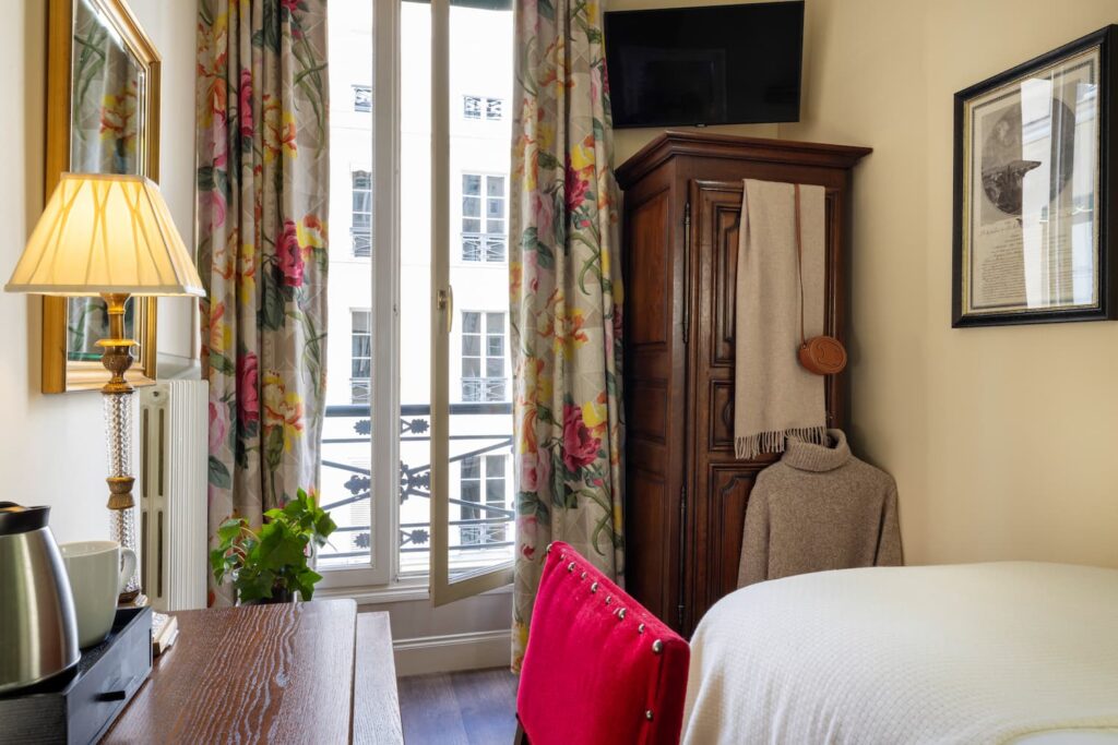 single room boutique hotel Paris with one large bed and a wooden desk