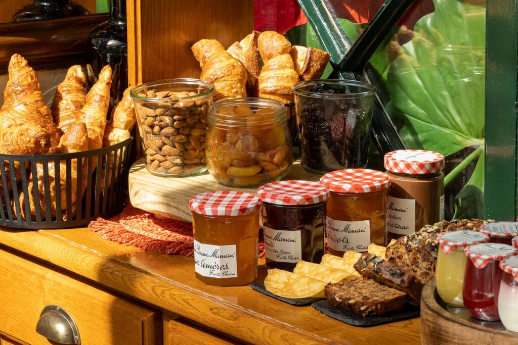 hotel near notre dame cathedral - breakfast buffet of the hotel des marronniers with pastries, marmelade and crepes