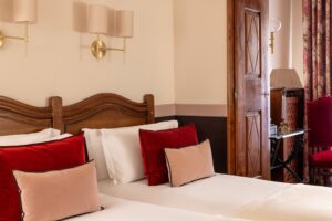 paris hotel with family rooms, two single beds and a wooden cupboard