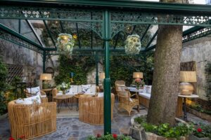 hotel in Paris - tables, sofa and armchairs in the garden - paris hotel 6th arrondissement hotel des marronniers
