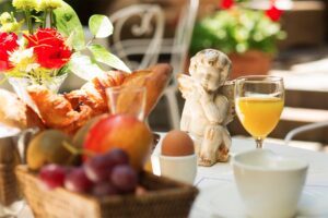 table settled for breakfast in the garden of the hotel des marronniers in Paris 6. LONG STAY OFFER BB